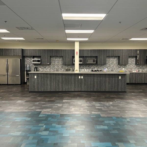 A spacious kitchen featuring a blue tile floor and matching blue cabinets