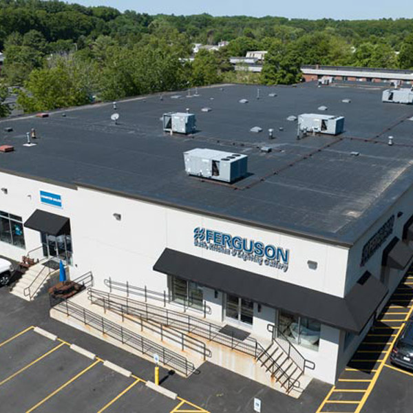 Aerial view of a warehouse with several trucks parked in front